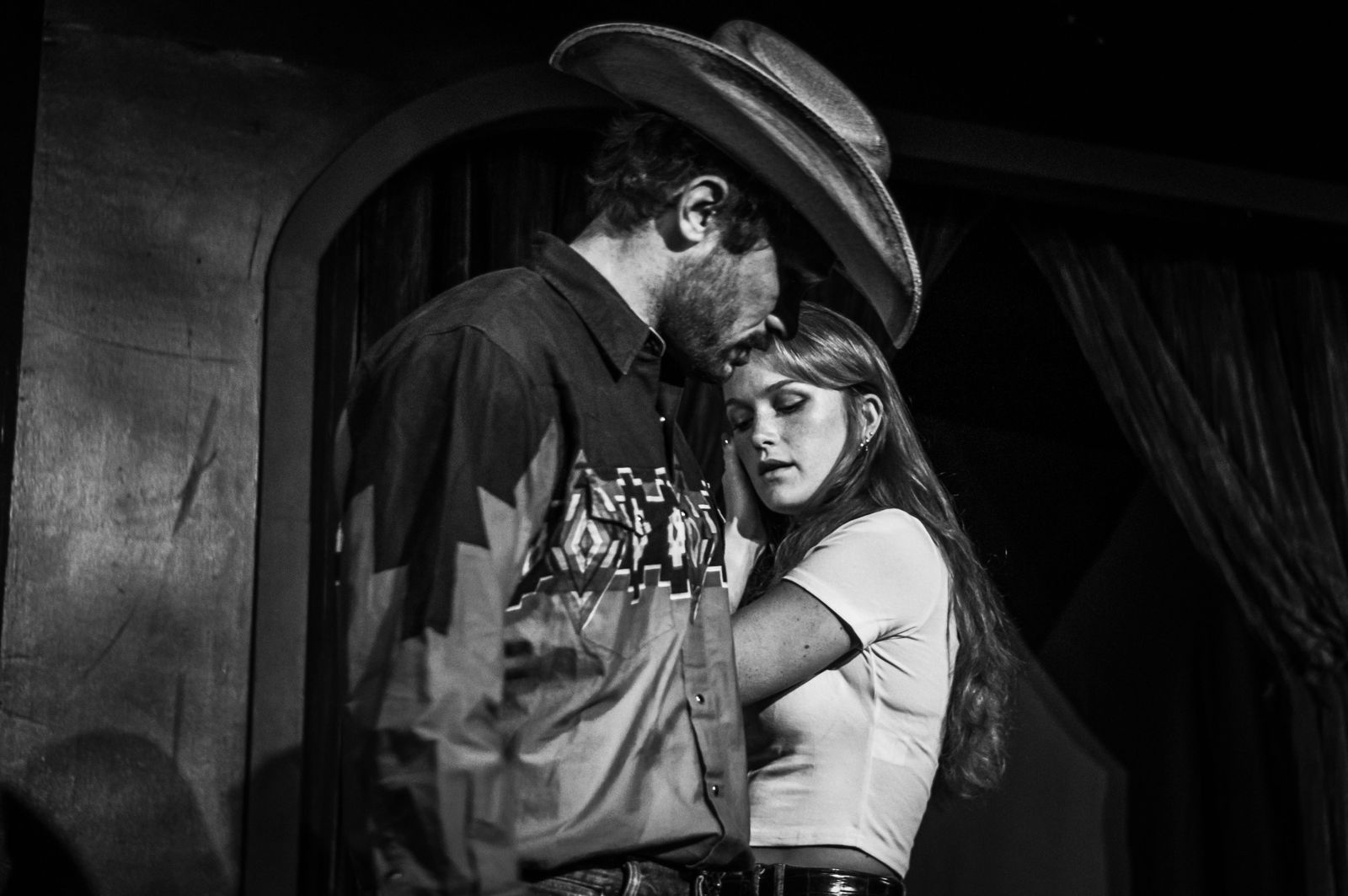 Two actors in an embrace on stage in Fool for Love