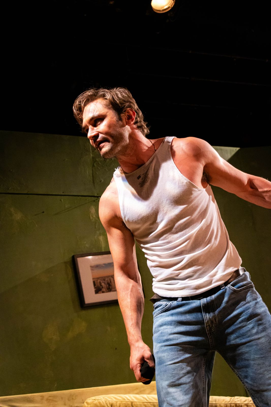 The Motherfucker with the Hat: an actor mid-monologue in a white tank top