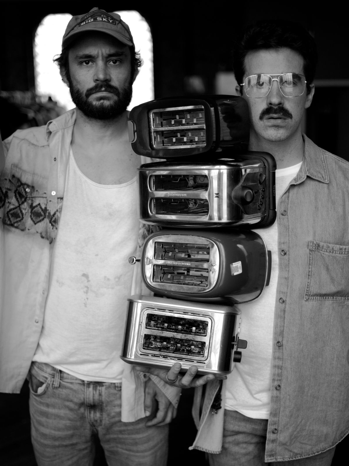 True West: two brothers, one holding a stack of toasters
